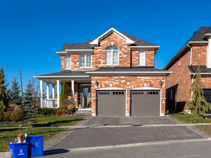 Large residential outdoor trash bins at a suburban home